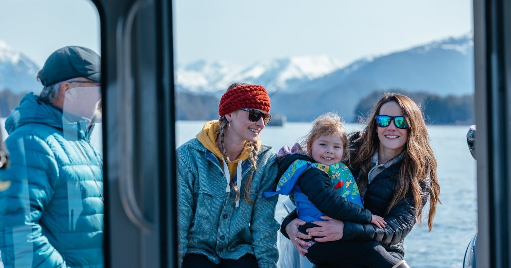 Small group enjoying Sitka boat tour with mountain views