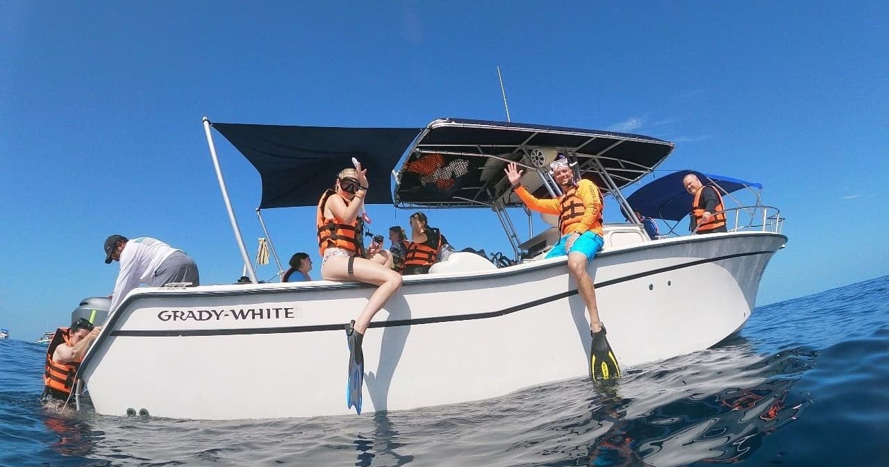 Passengers lounging on boat deck before whale shark snorkeling trip