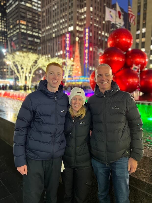 Couple and teen by holiday lights and decorations in Midtown NYC