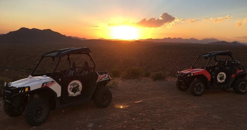 UTV tour at sunset over desert ridgeline, off-road adventure