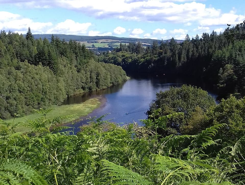 River valley bike route winding through forested Highland scenery