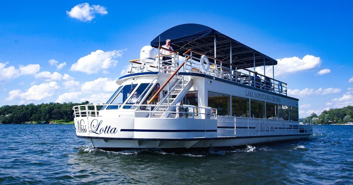 Sightseeing cruise boat on a sunny lake with clear blue skies