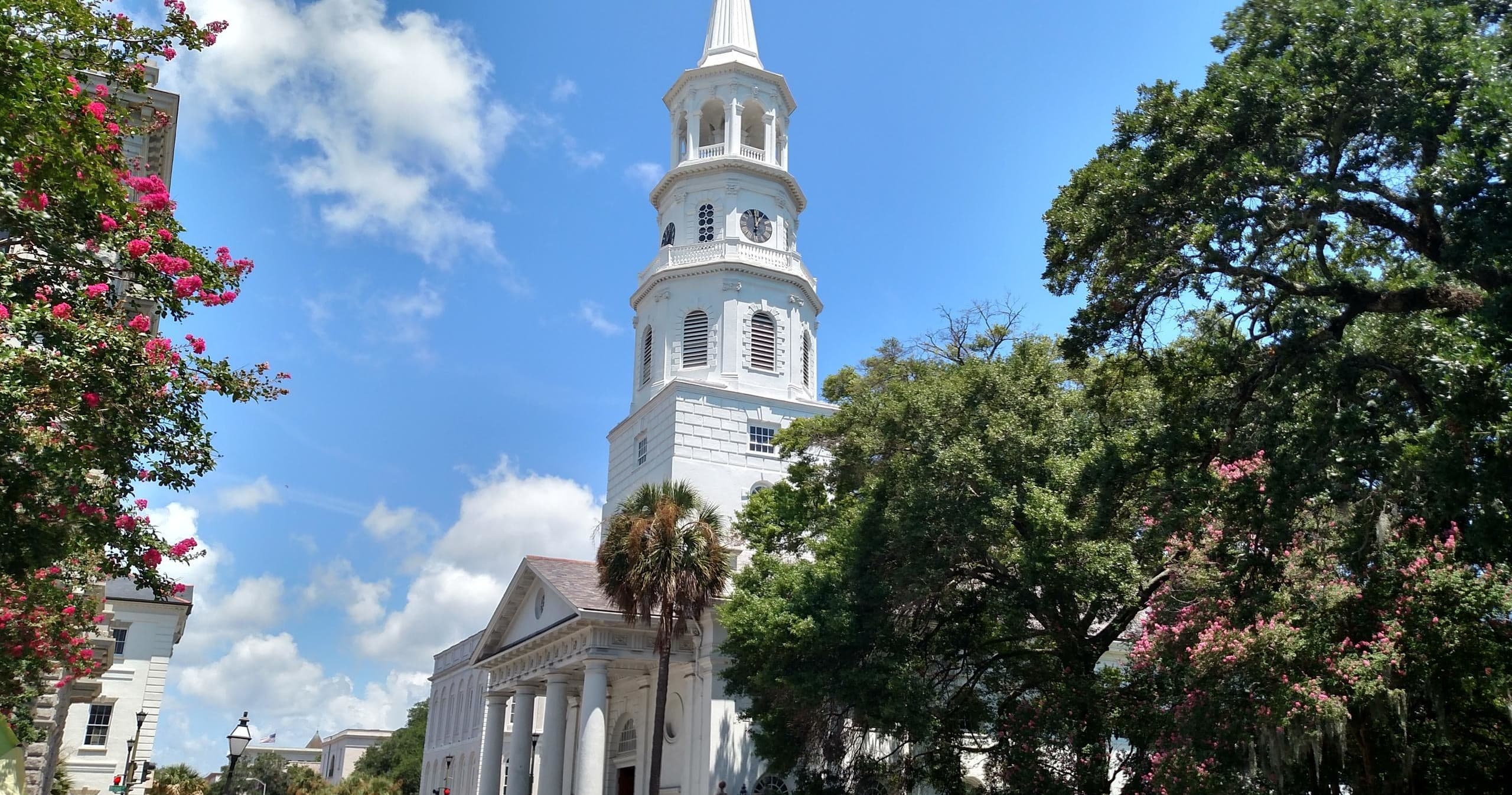 Historic church steeple and live oaks in Charleston walking tour