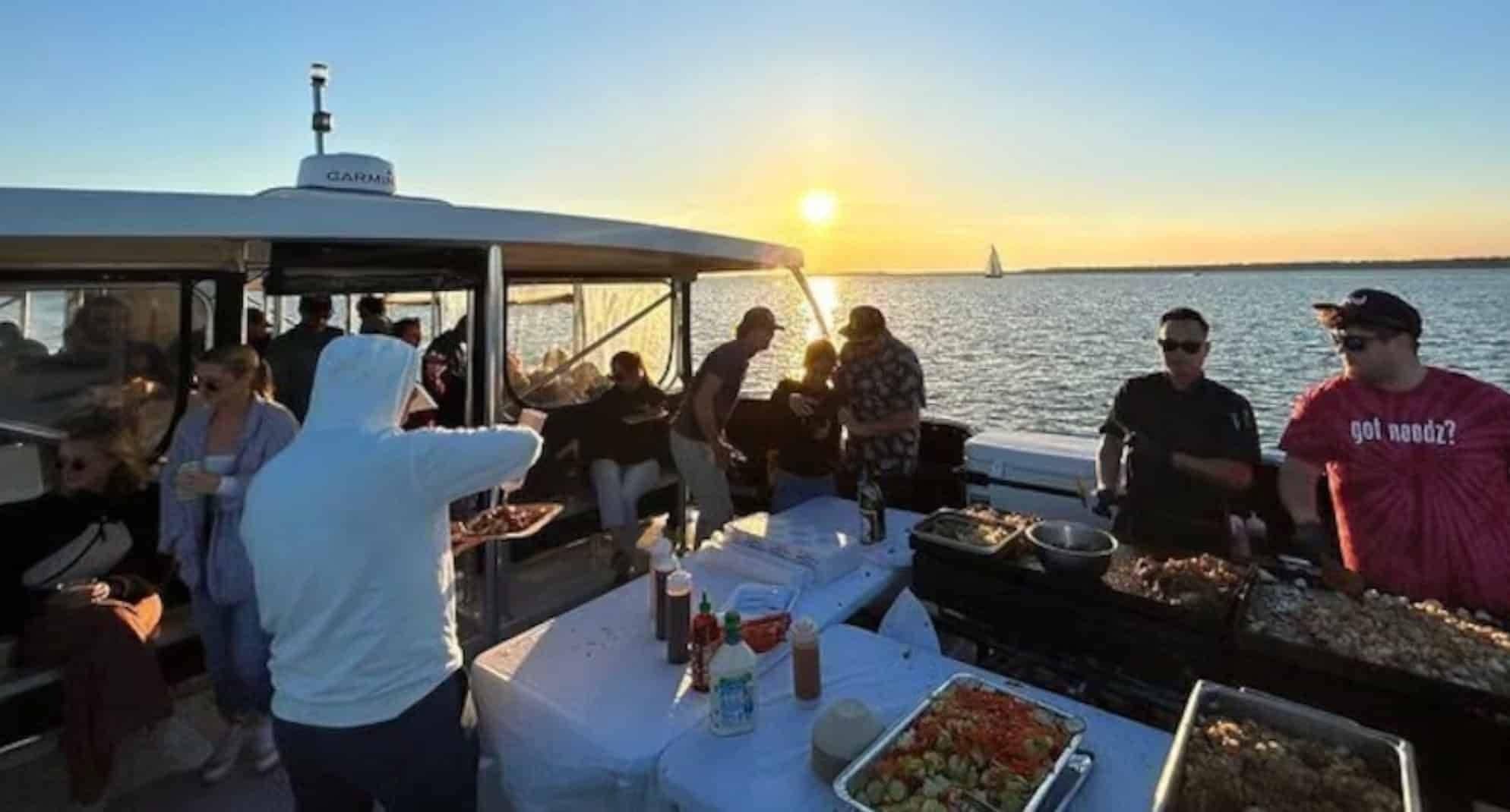 Sunset charter boat deck with guests dining and socializing