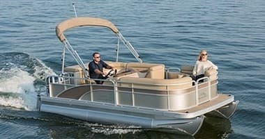 Pontoon boat cruising on Lake Placid waters with passengers