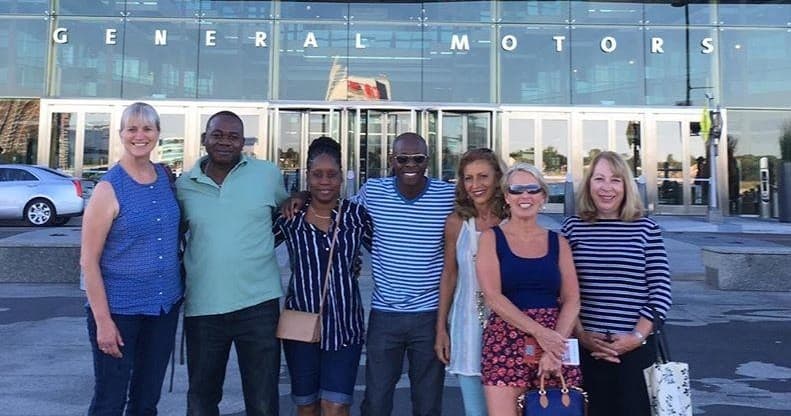 Guided city tour group outside General Motors building in Detroit