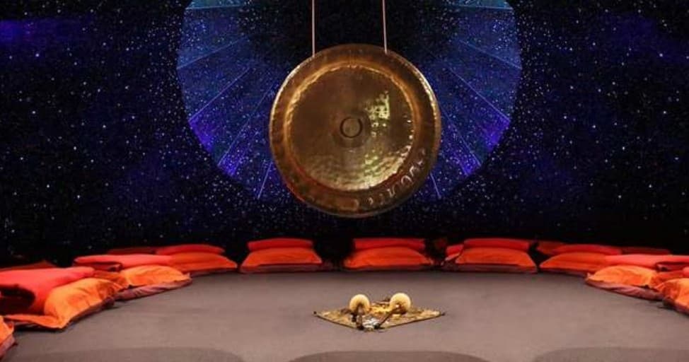 Gong meditation circle in cozy indoor studio with cushions
