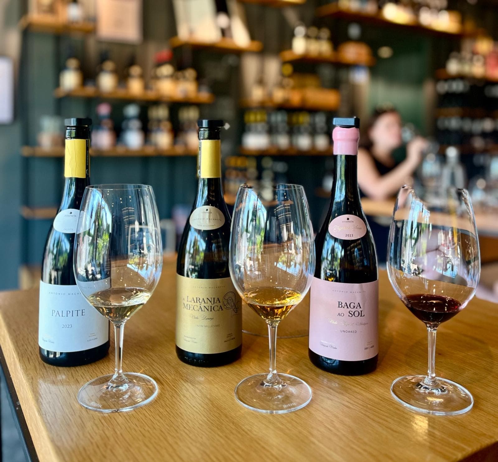 Wine tasting setup with bottles and glasses on wooden table
