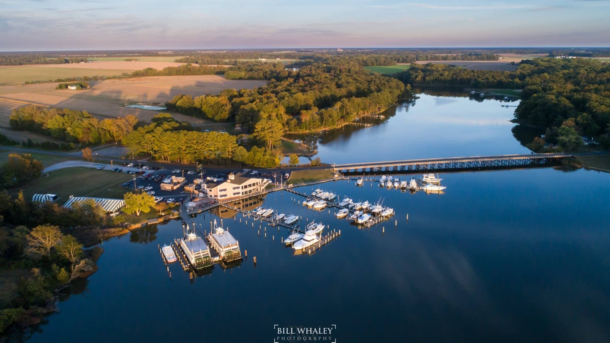 Aerial view of marina and estuary with boats at sunrise