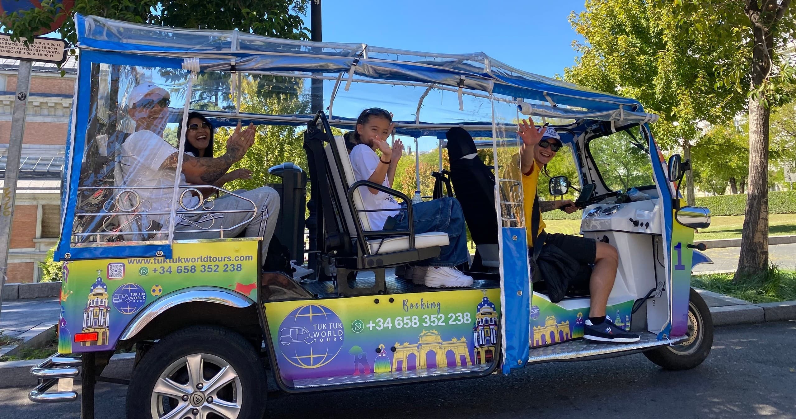 Open-air tuk-tuk city tour with passengers on sunny street