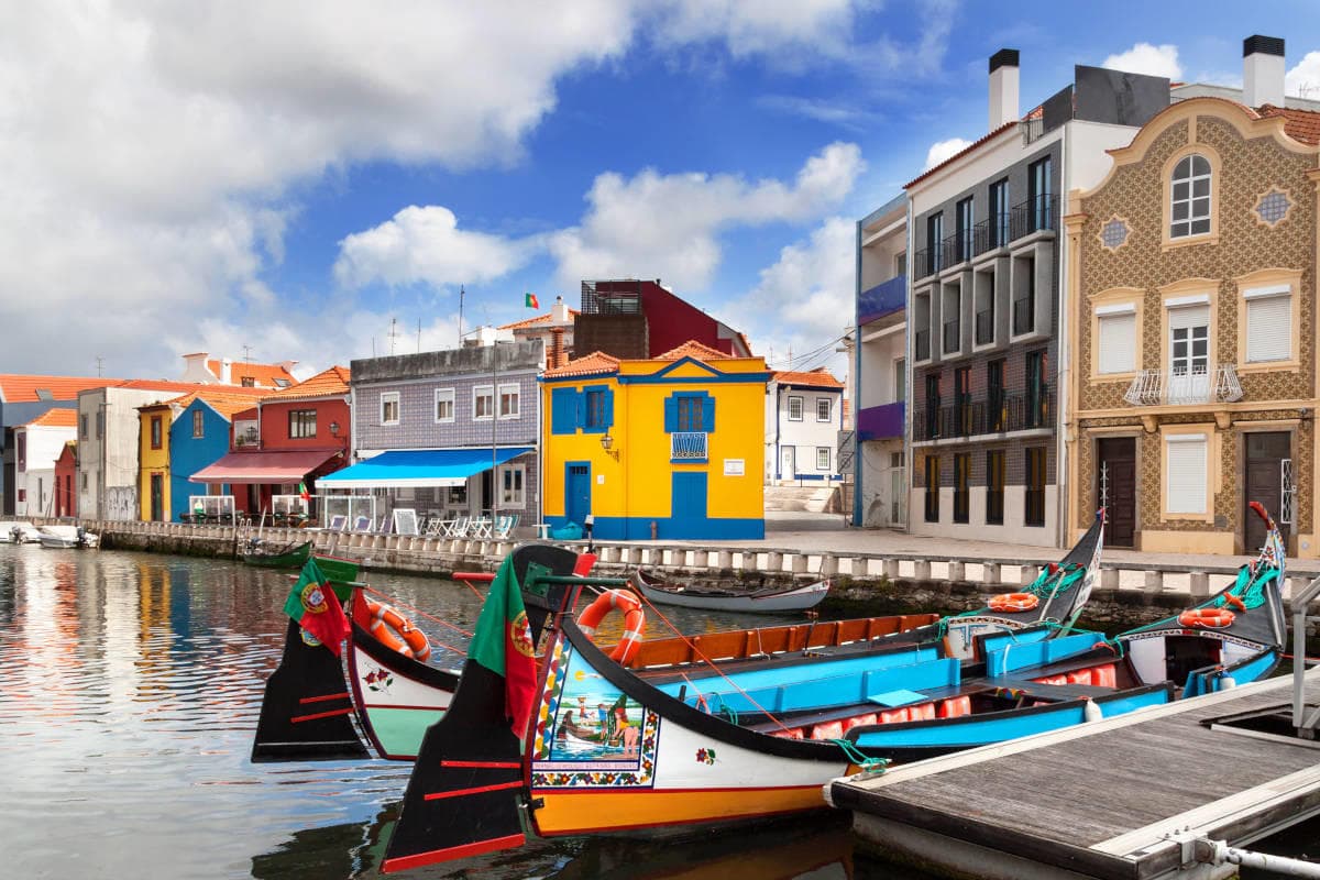 Colorful traditional boats moored along picturesque coastal canal
