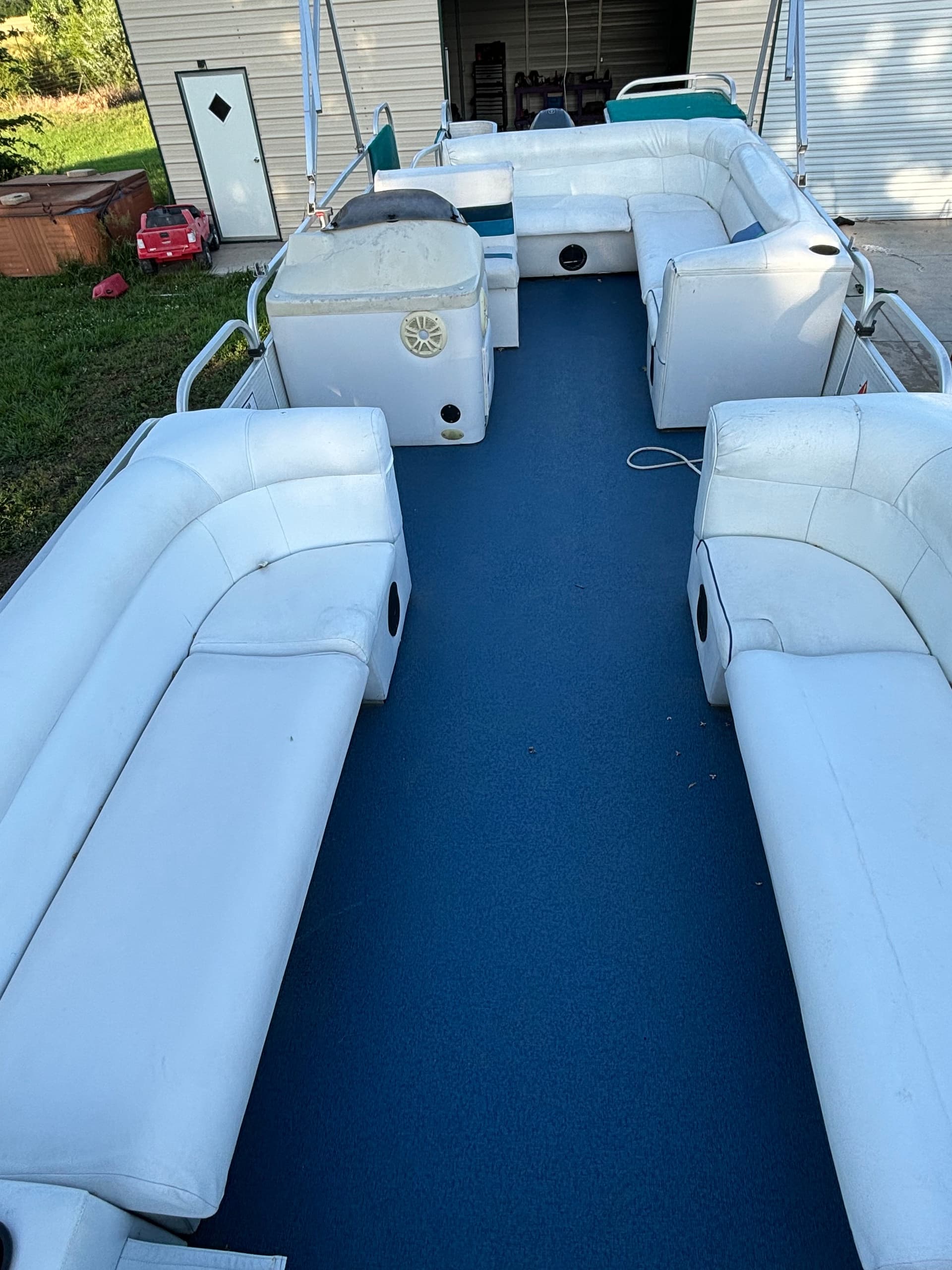 Pontoon boat blue deck center aisle, spacious seating for cruising