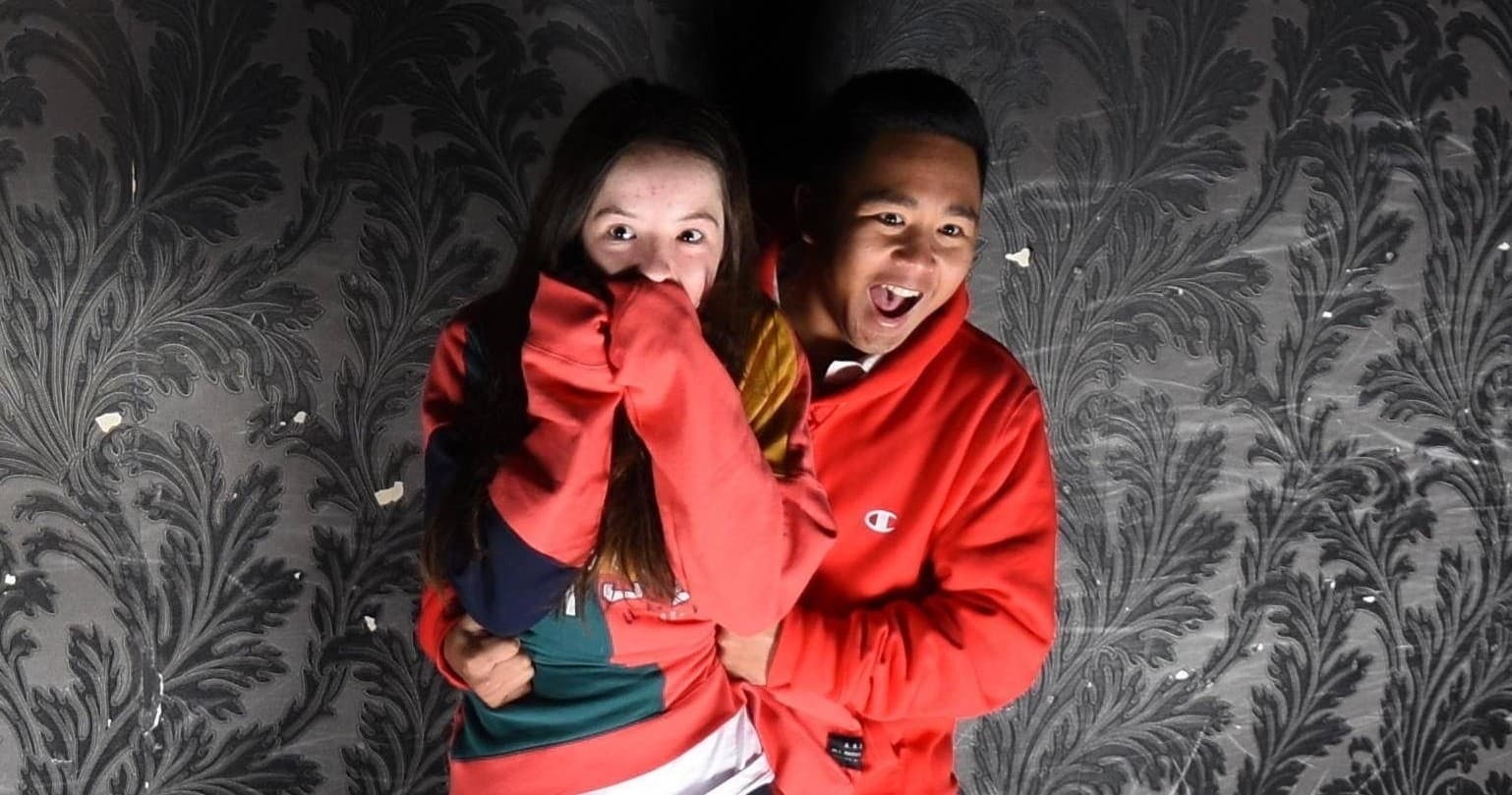 Couple startled inside dark haunted house attraction in Queenstown