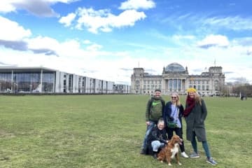 Tourists posing on lawn near Reichstag building in Berlin