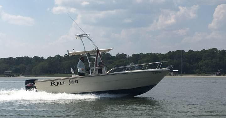 Charter fishing boat speeding across coastal bay waters