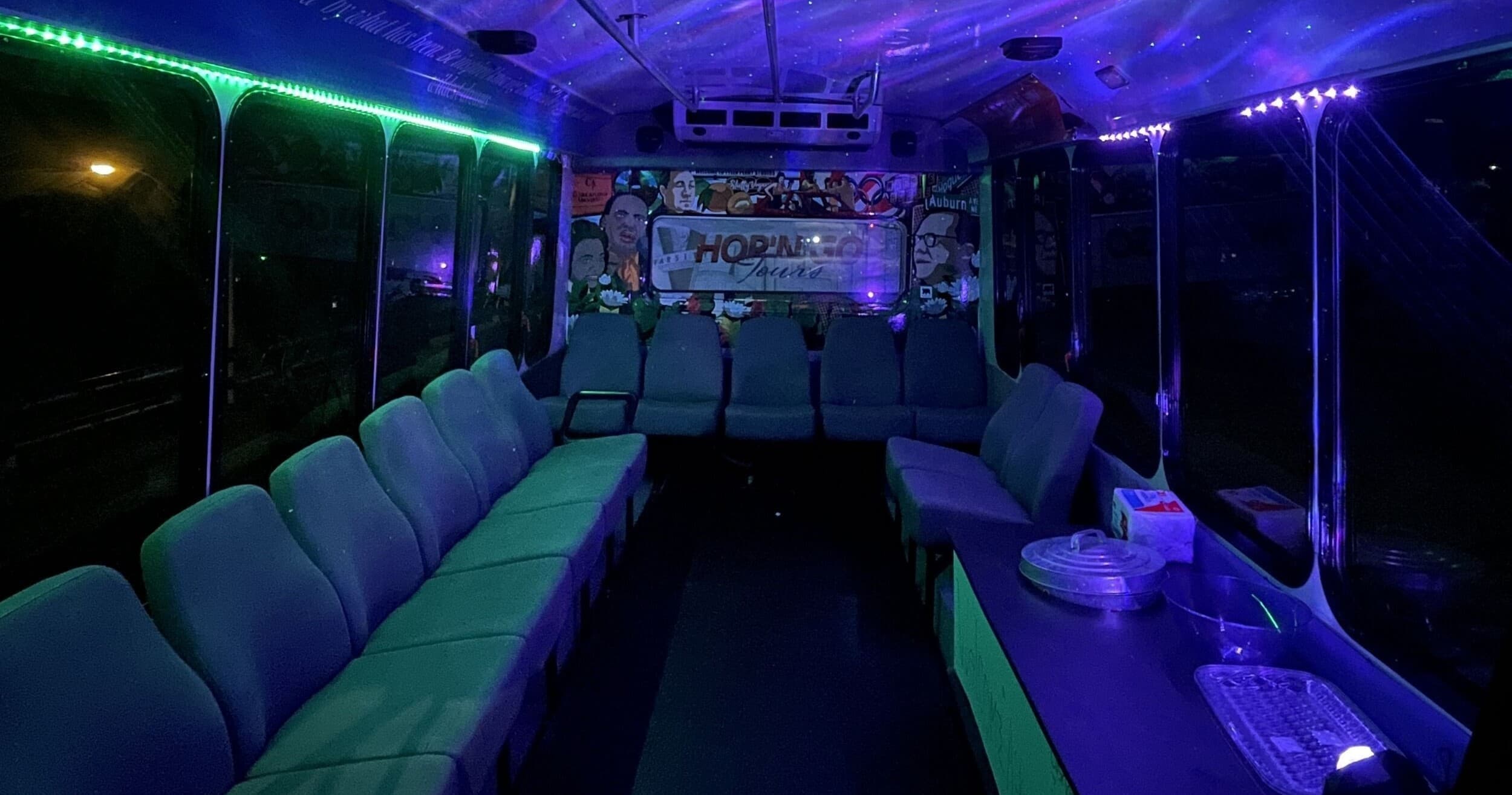 Neon-lit party shuttle interior with lounge seating for groups