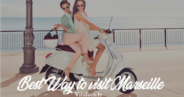 Two women on Vespa along Marseille promenade, seaside