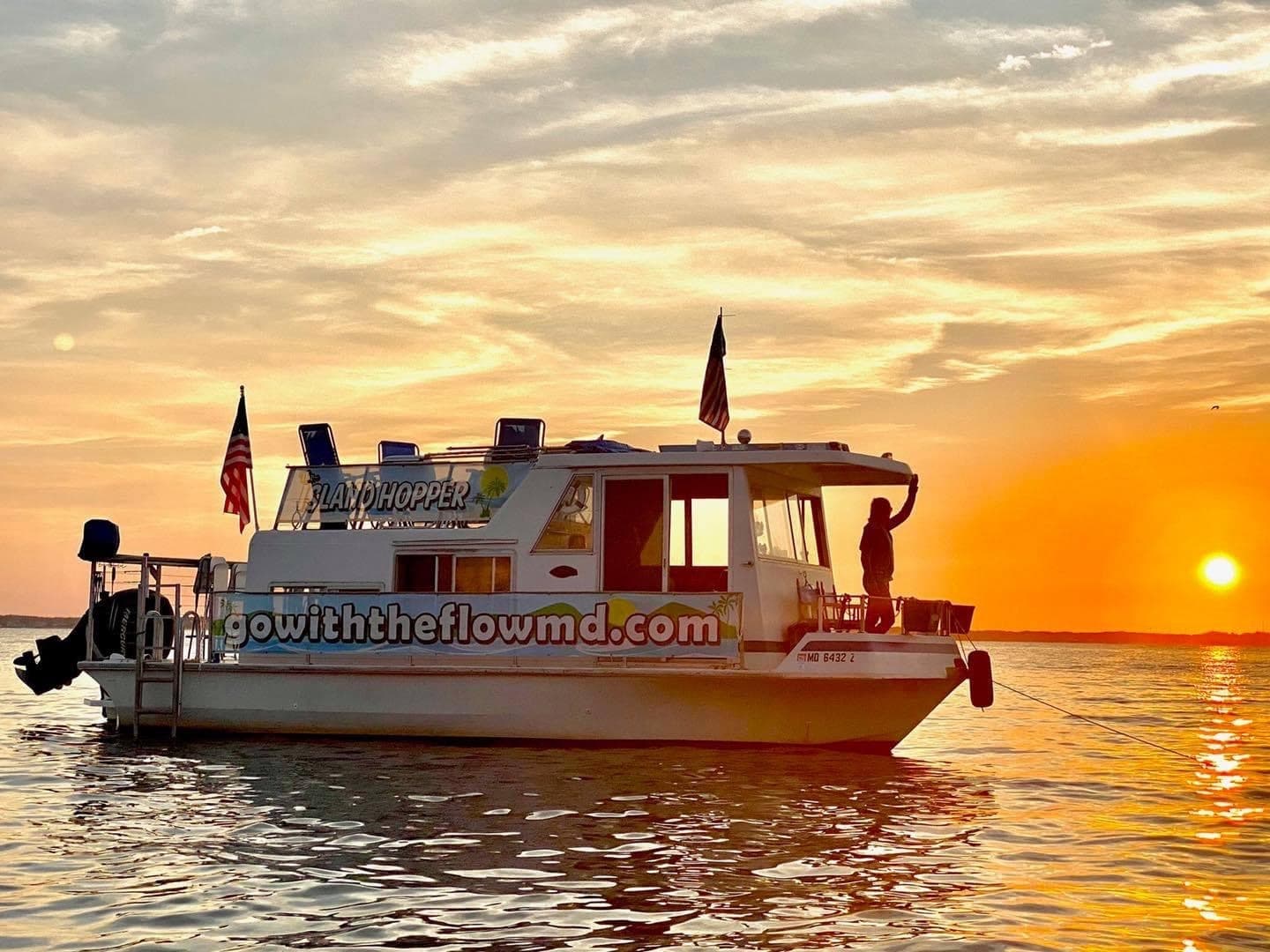 Sunset sightseeing boat cruise on Maryland waters, passengers enjoying view