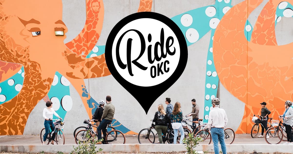 Community cyclists gathered by colorful mural in Oklahoma City