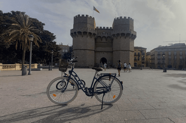 Bicycle parked in Valencia square near medieval gate tower