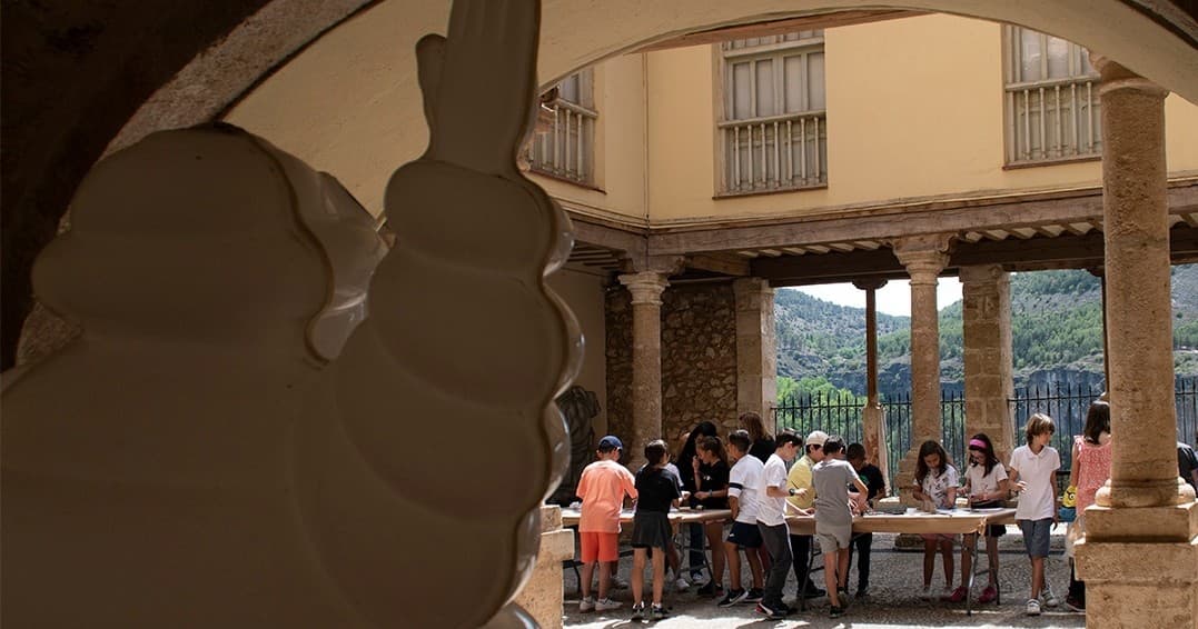 Group tour gathering in historic outdoor courtyard with columns