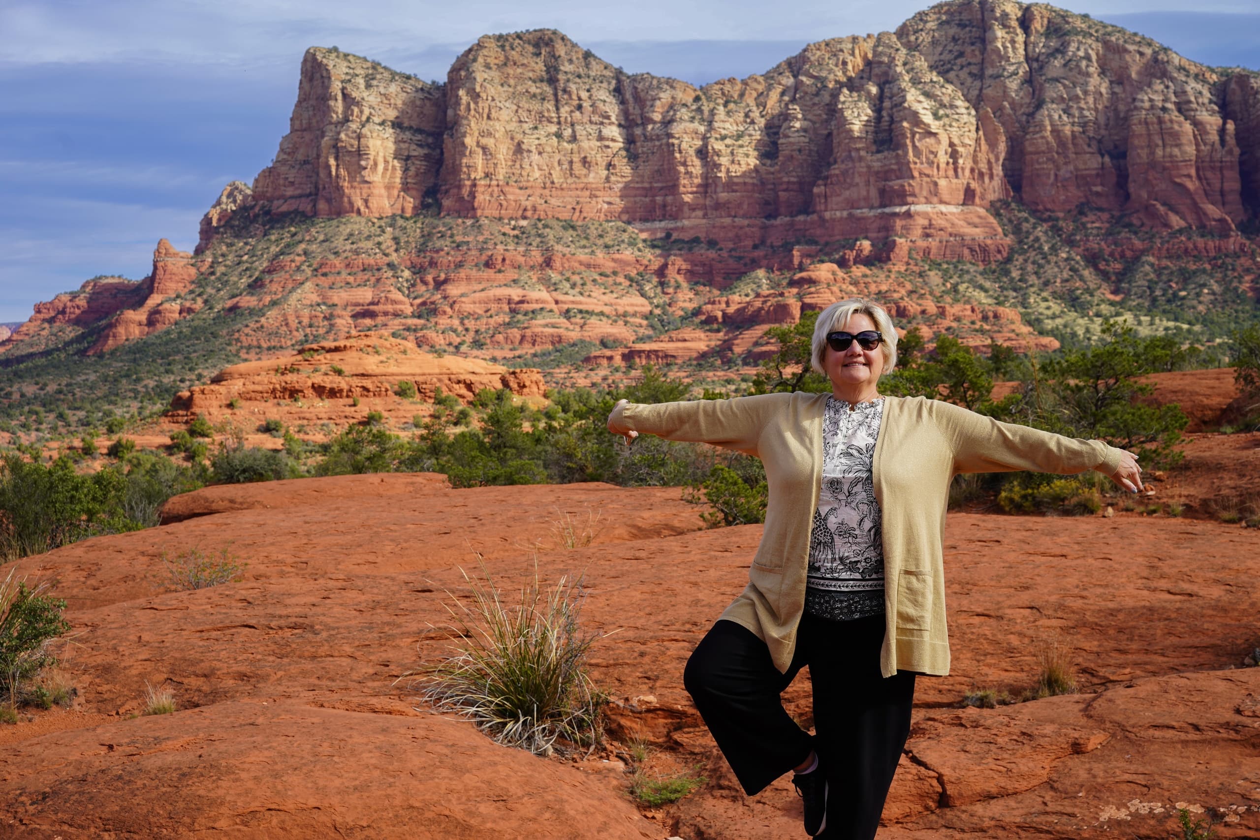 Person posing in Sedona red rock landscape during scenic desert hike