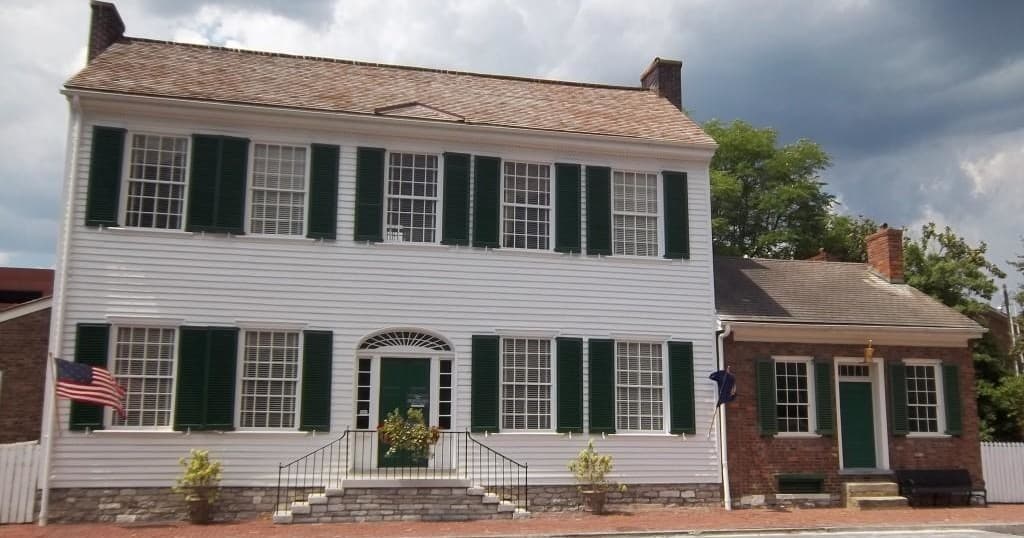 Historic McDowell House exterior on brick street, heritage home visit experience
