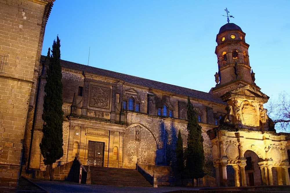 Illuminated historic church and tower at dusk, evening walking tour