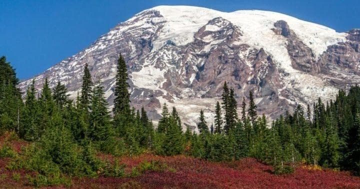 Snow-capped mountain and alpine meadow, scenic mountaineering vista