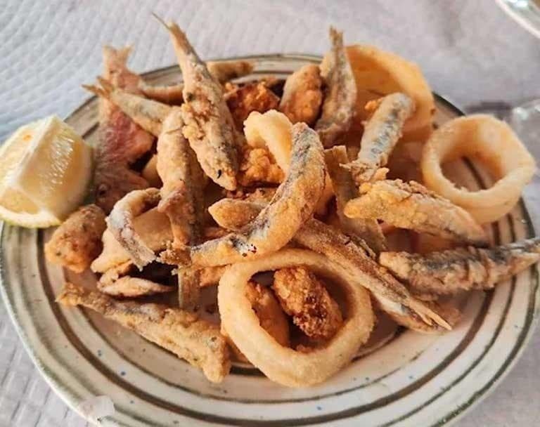 Fried seafood platter with calamari and anchovies - beach snack