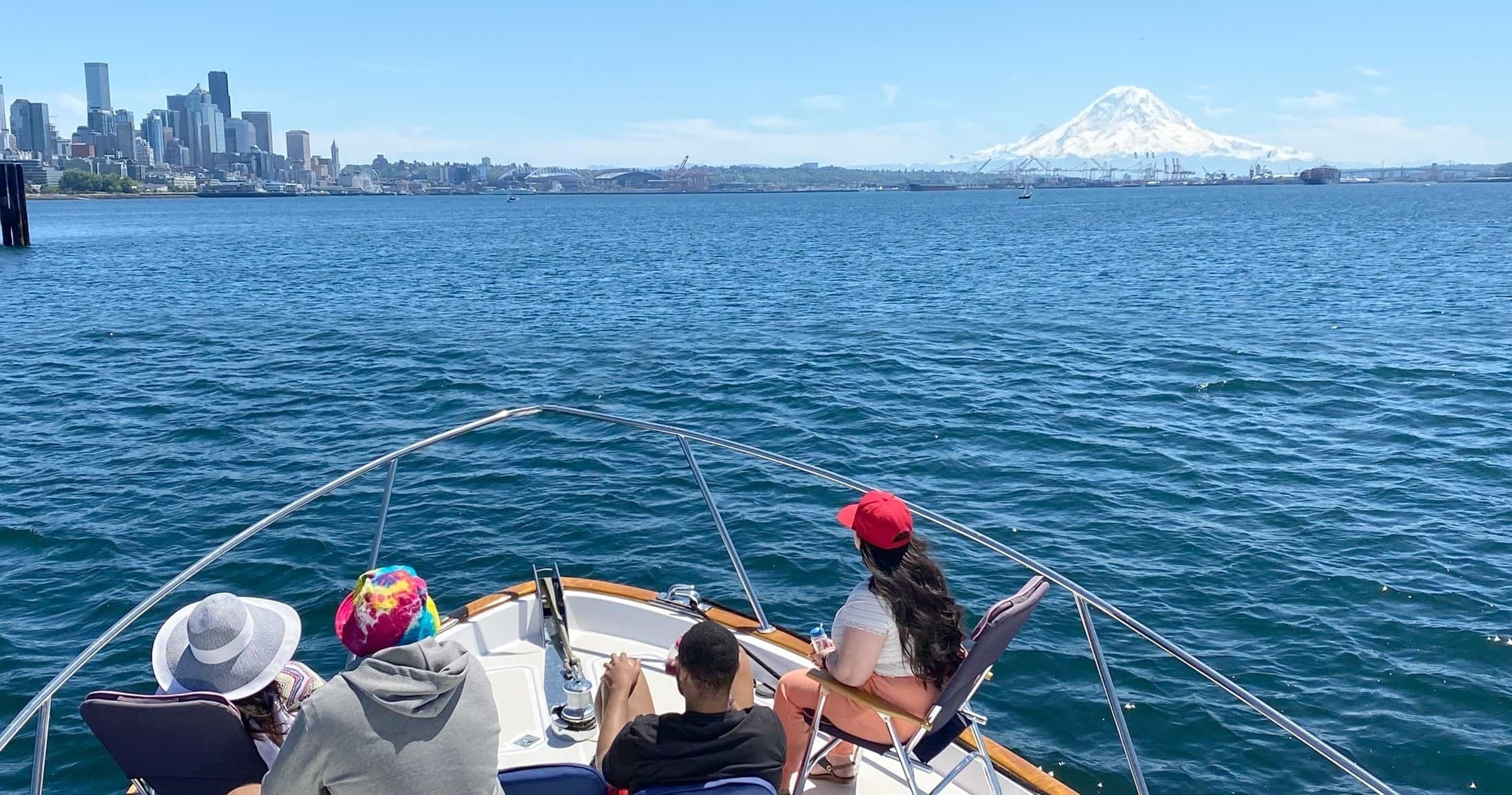 Passengers enjoying Seattle harbor cruise with Mt. Rainier view