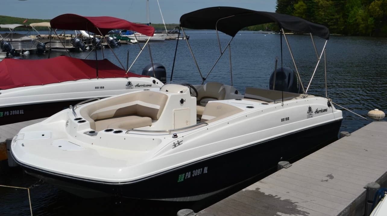 Sleek deck boat docked at lake marina, family day boating