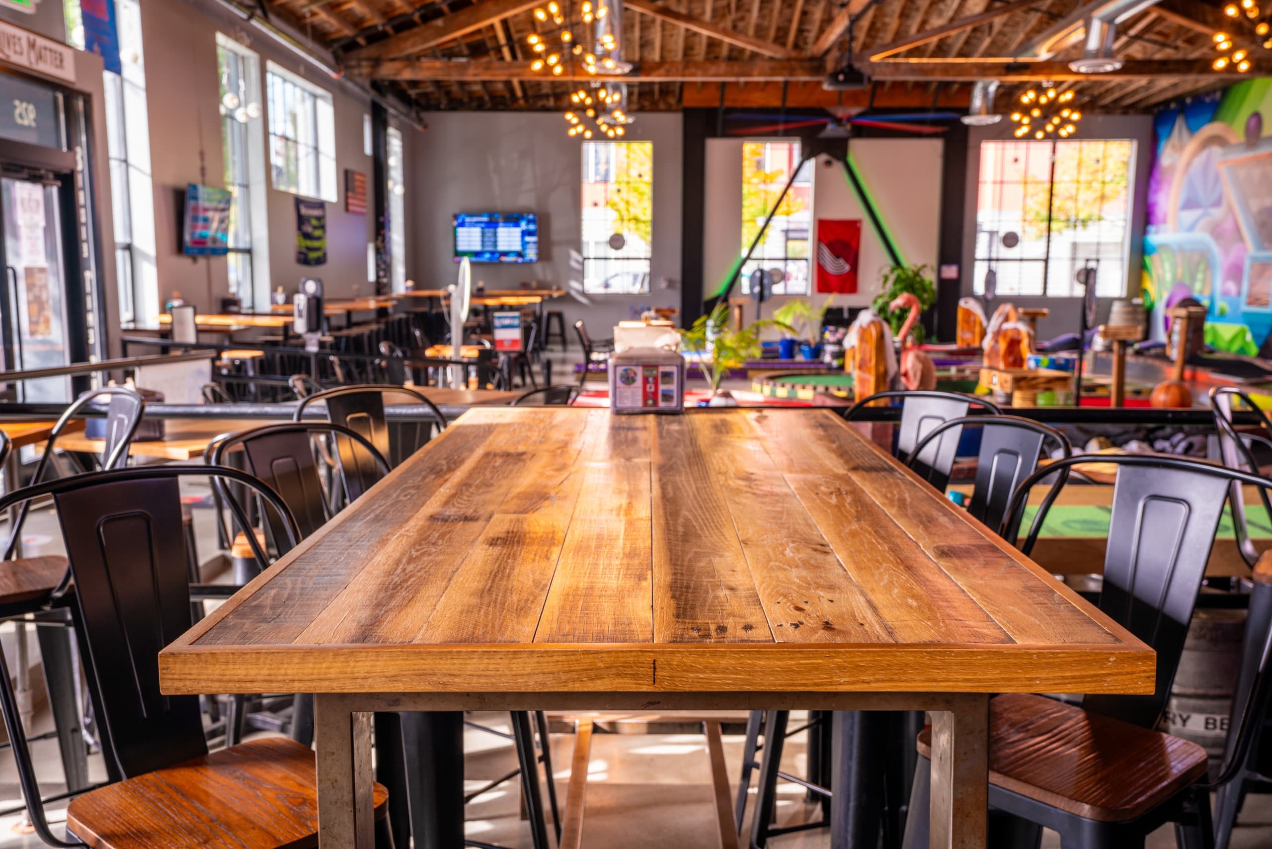 Large community table in pub with rustic wood and ambient lights
