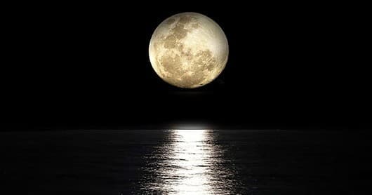 Full moon reflecting over open water, night seascape