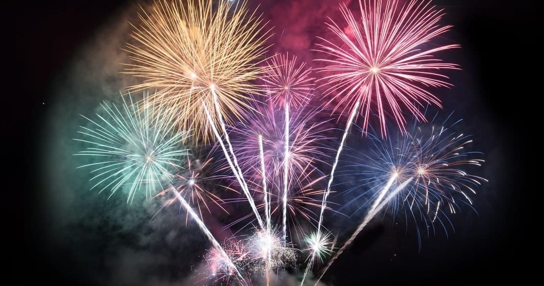 Colorful fireworks display over dark sky, evening celebration outdoors
