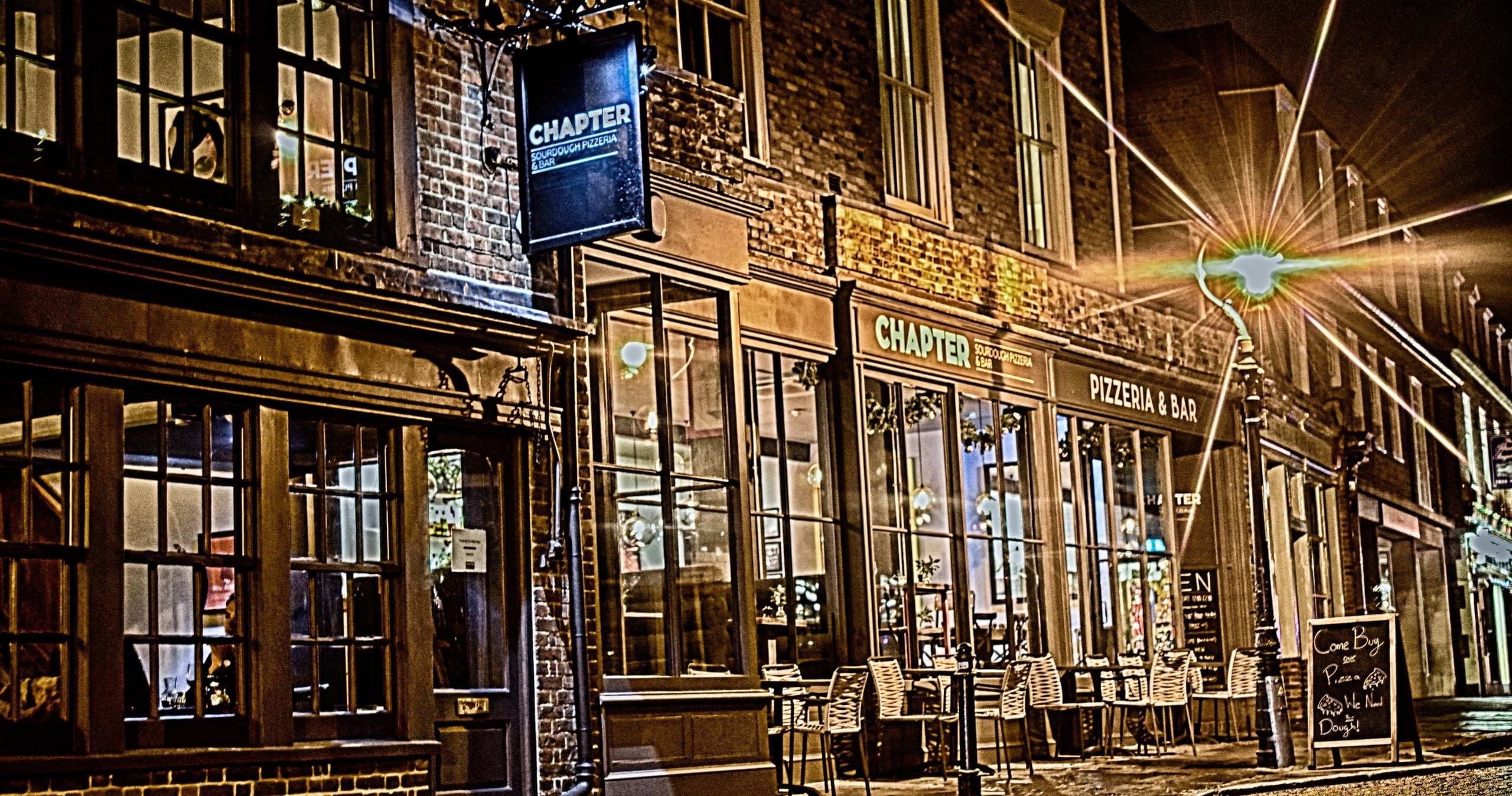 Historic riverside pub exterior lit at night in Canterbury