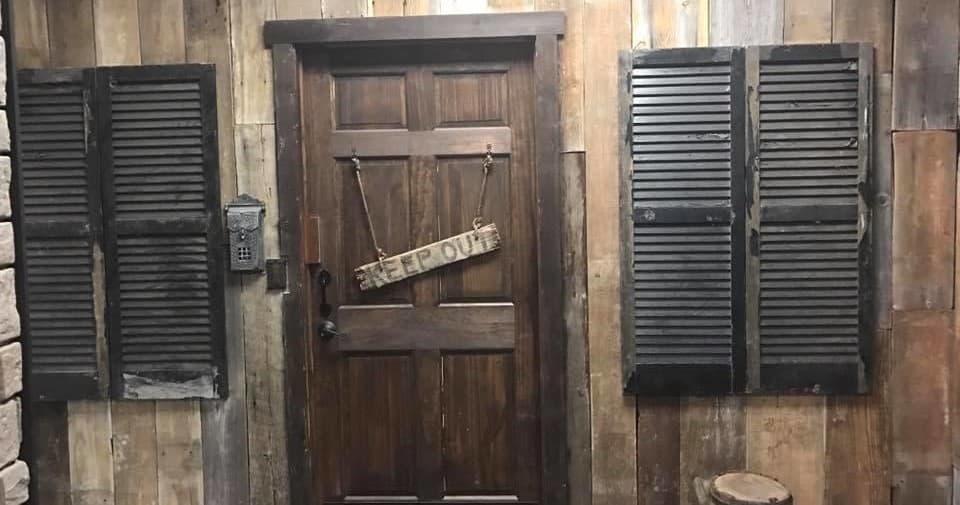 Rustic wooden door and shutters in themed indoor escape room