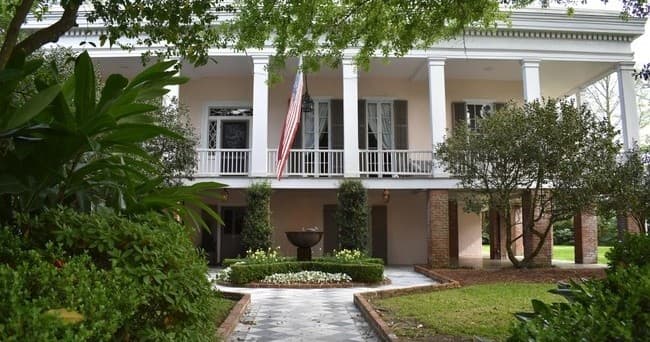 Antebellum mansion with double-columned portico and shaded walkway