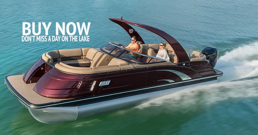 Luxury pontoon cruising on lake at speed, wake and motion