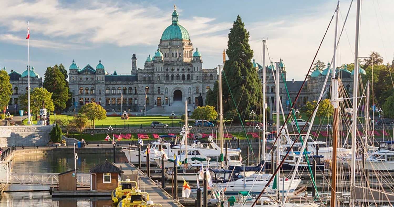 Sailboats in Victoria Inner Harbour with Parliament building