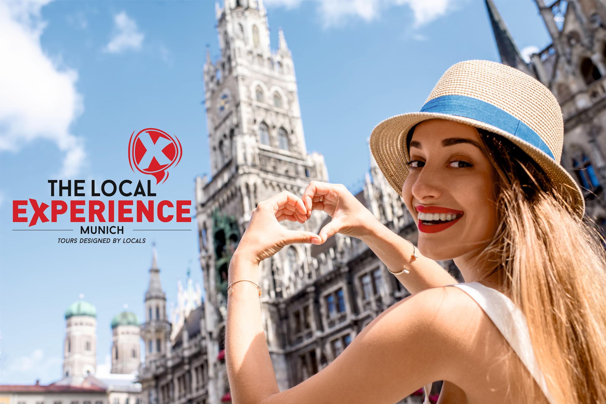 Woman making heart gesture in front of Munich Neues Rathaus