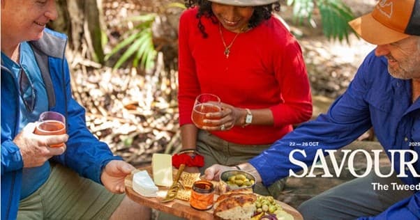 Outdoor picnic with people sampling local food in bush setting