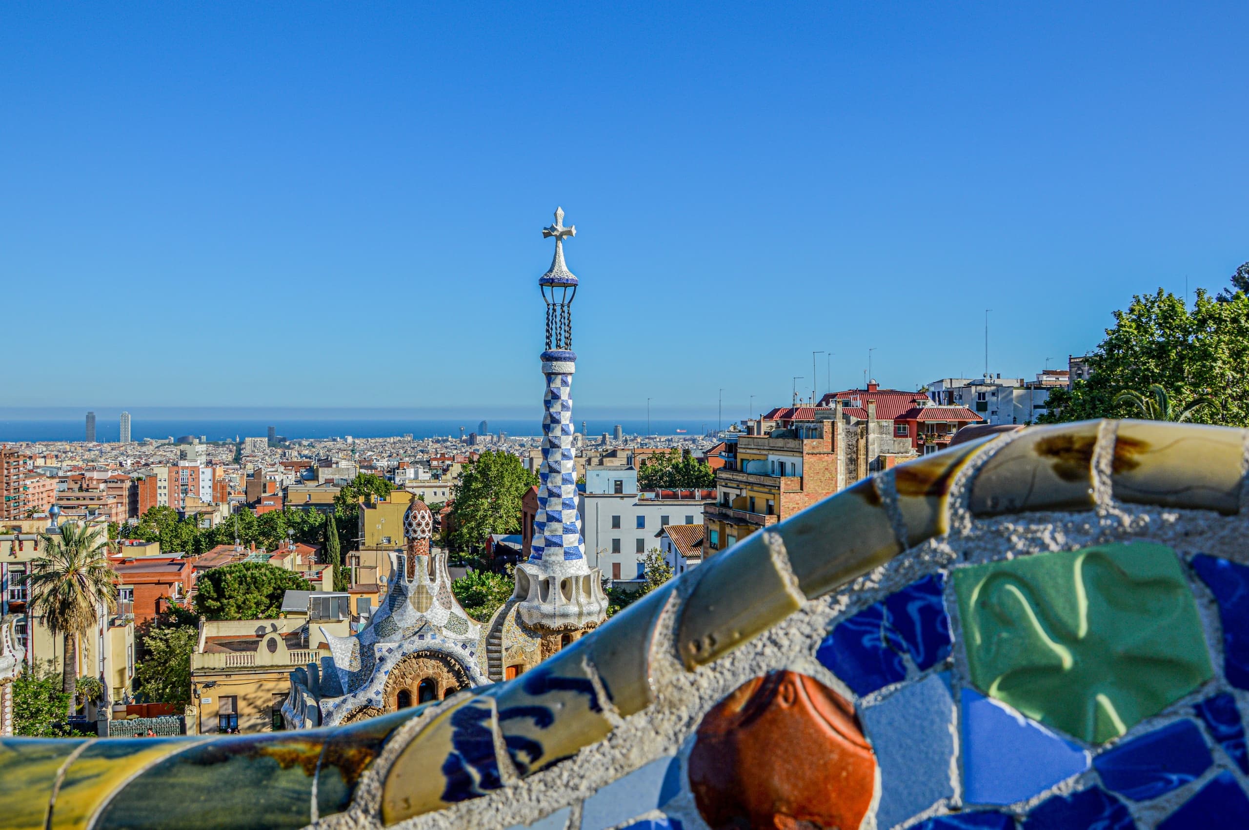 Park Güell mosaic bench overlooking Barcelona skyline, outdoor view