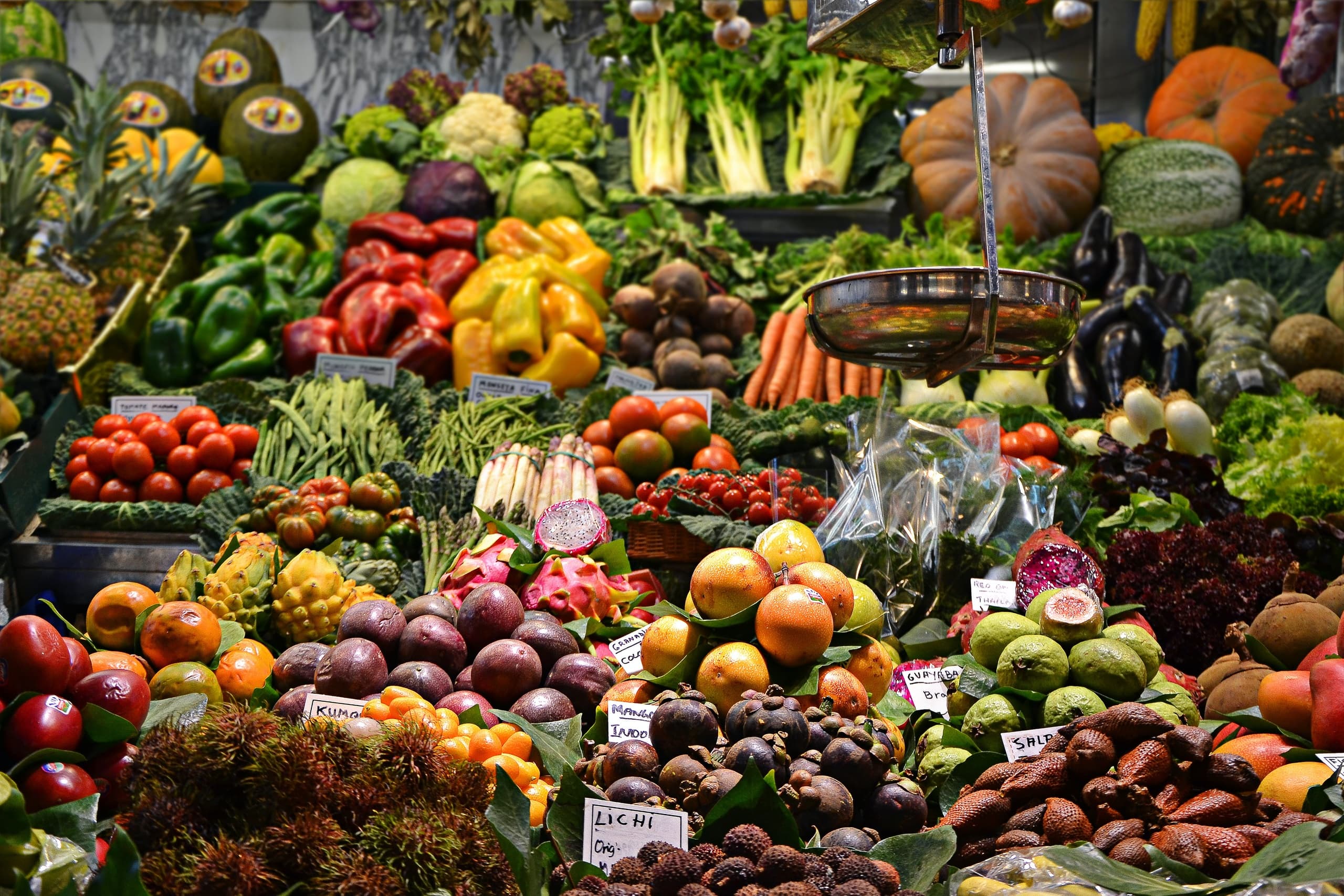 Colorful fresh produce display at outdoor farmers market stall