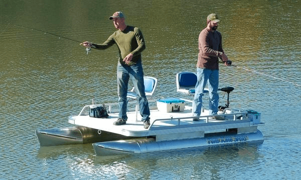 Two anglers fishing from a pontoon boat on a tranquil lake