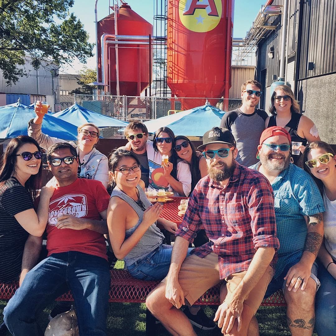 Friends enjoying outdoor brewery beer garden in Austin