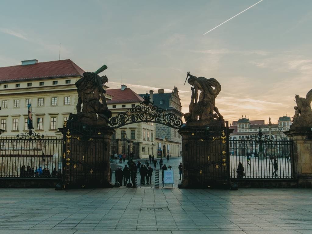 Historic Charles Bridge statues at dawn over Vltava River