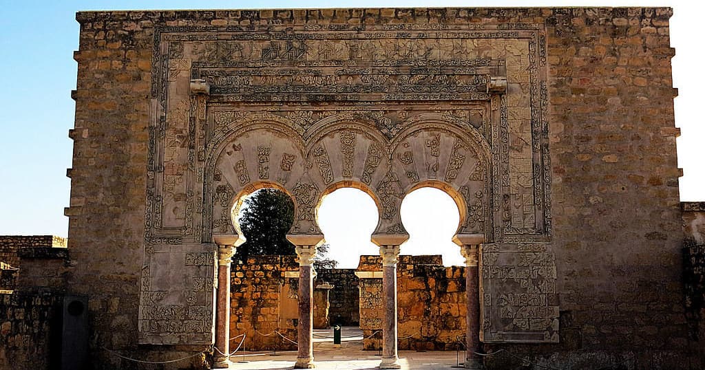 Ornate horseshoe arches framing courtyard at Medina Azahara ruins