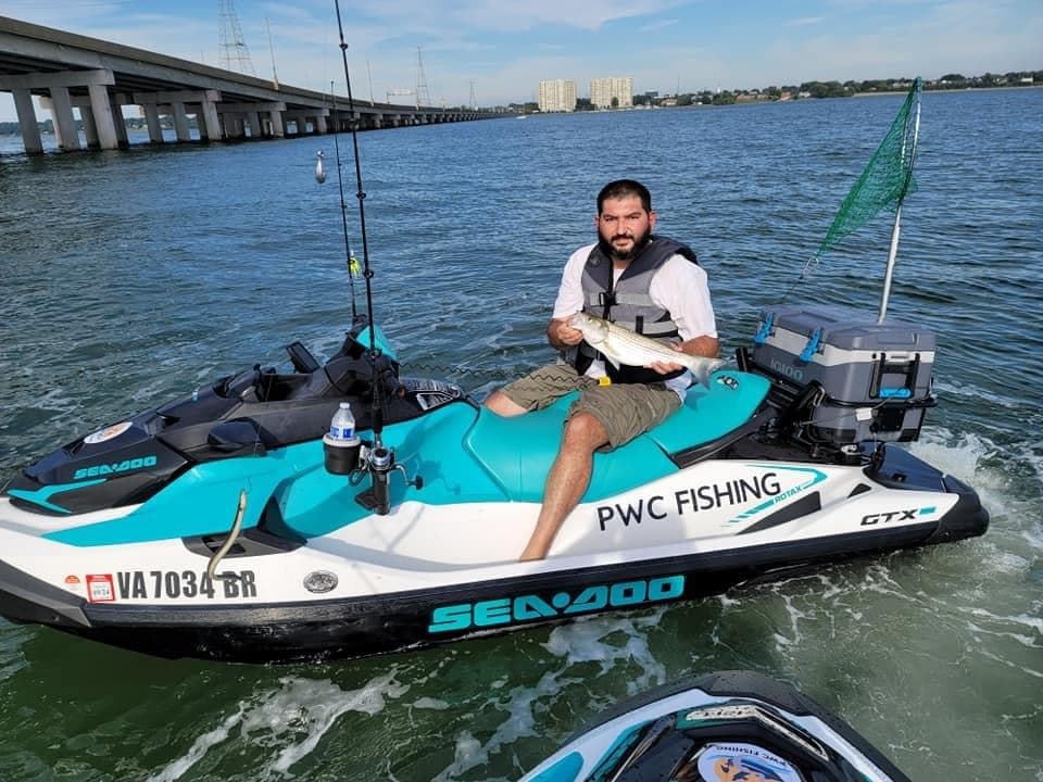 Angler on PWC fishing near bridge, recreational offshore jet ski fishing