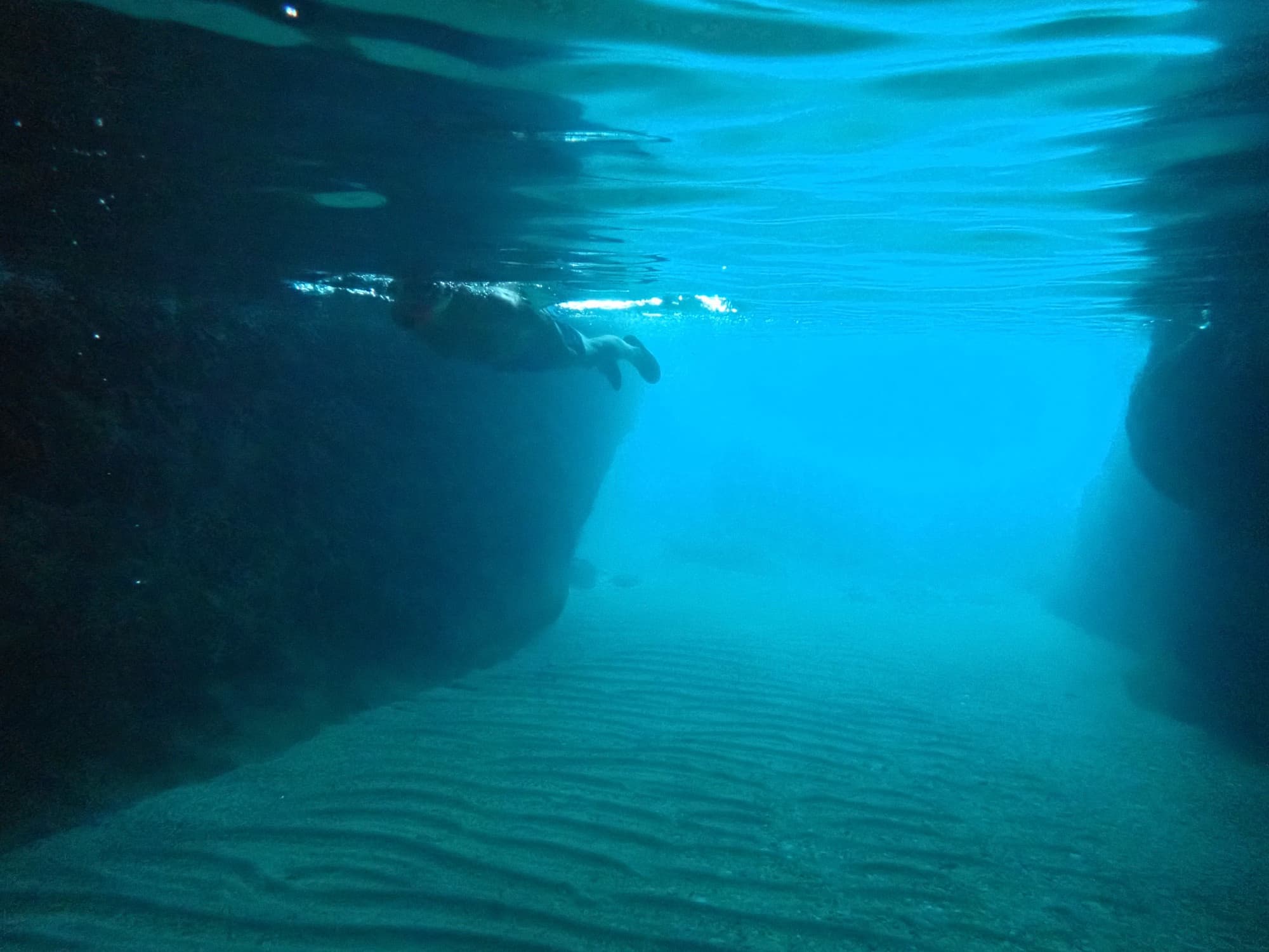 Underwater sea cave passage with sunlight beams in Cyprus waters